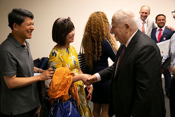 Vartan Gregorian, president of Carnegie Corporation of New York, congratulating new U.S. citizens following the naturalization ceremony on July 18 at the JFK Library.