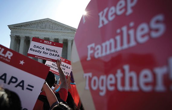 Pro-immigration activists gather in front of the U.S. Supreme Court on April 18, 2016, as the court hears oral arguments in the case of 