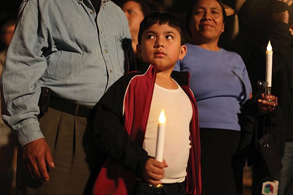 In Homestead, Florida, Rodrigo Hernandez, whose family is originally from Guatemala, attends a vigil with his family to protest against the deportation of undocumented immigrants, January 6, 2016. (Photo: Joe Raedle/Getty Images)