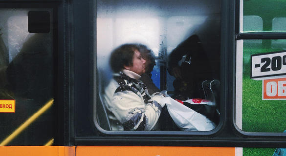 Inside the train, shoulders are wedged among shoulders and bodies breathe the same sticky air, but no eyes make contact.