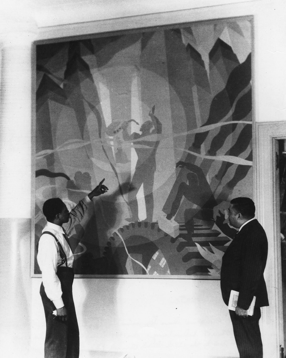 Aaron Douglas (left) discusses his new painting “Song of the Towers” in 1934 with Schomburg Collection curator Arturo Alfonso Schomburg. (Photo: The New York Public Library, Schomburg Center for Research in Black Culture, Art and Artifacts Division)