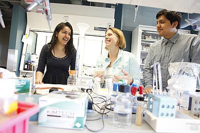 Brandeis University biology professor Melissa Kosinski-Collins (center) with students; photo courtesy Brandeis University