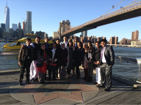 Young Pakistani visitors pose in front of a New York City icon: the Brooklyn Bridge.