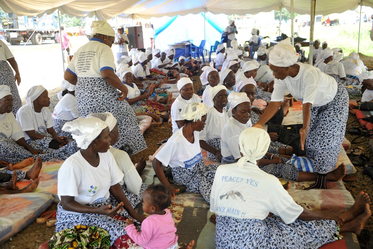 Members of the Women in Peacebuilding Network sit on mattresses under a tent as they fast to call for peaceful elections in Monrovia on October 5, 2017. (Zoom Dosso/AFP via Getty Images)