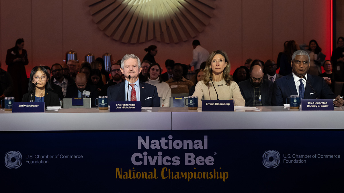 A panel of four judges at a table