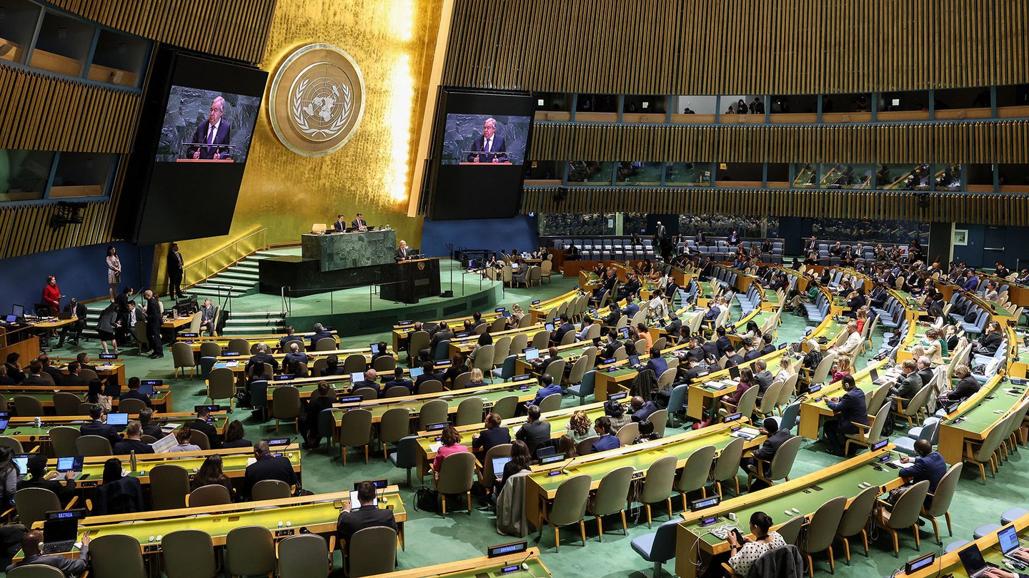 United Nations assembly room with people at desks facing speakers